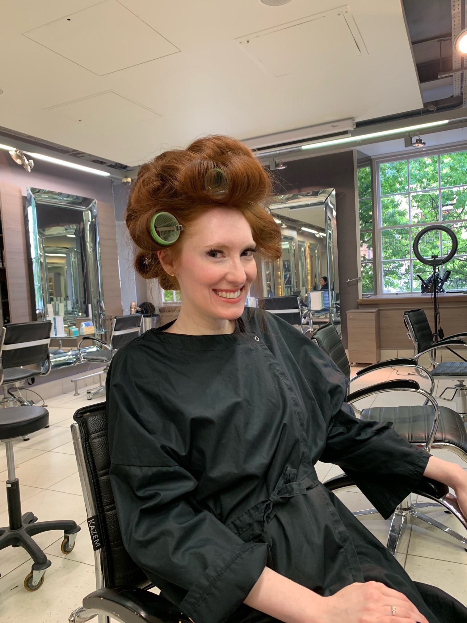 Kristin Contino wearing a black salon gown with her hair in rollers at the Richard Ward Salon