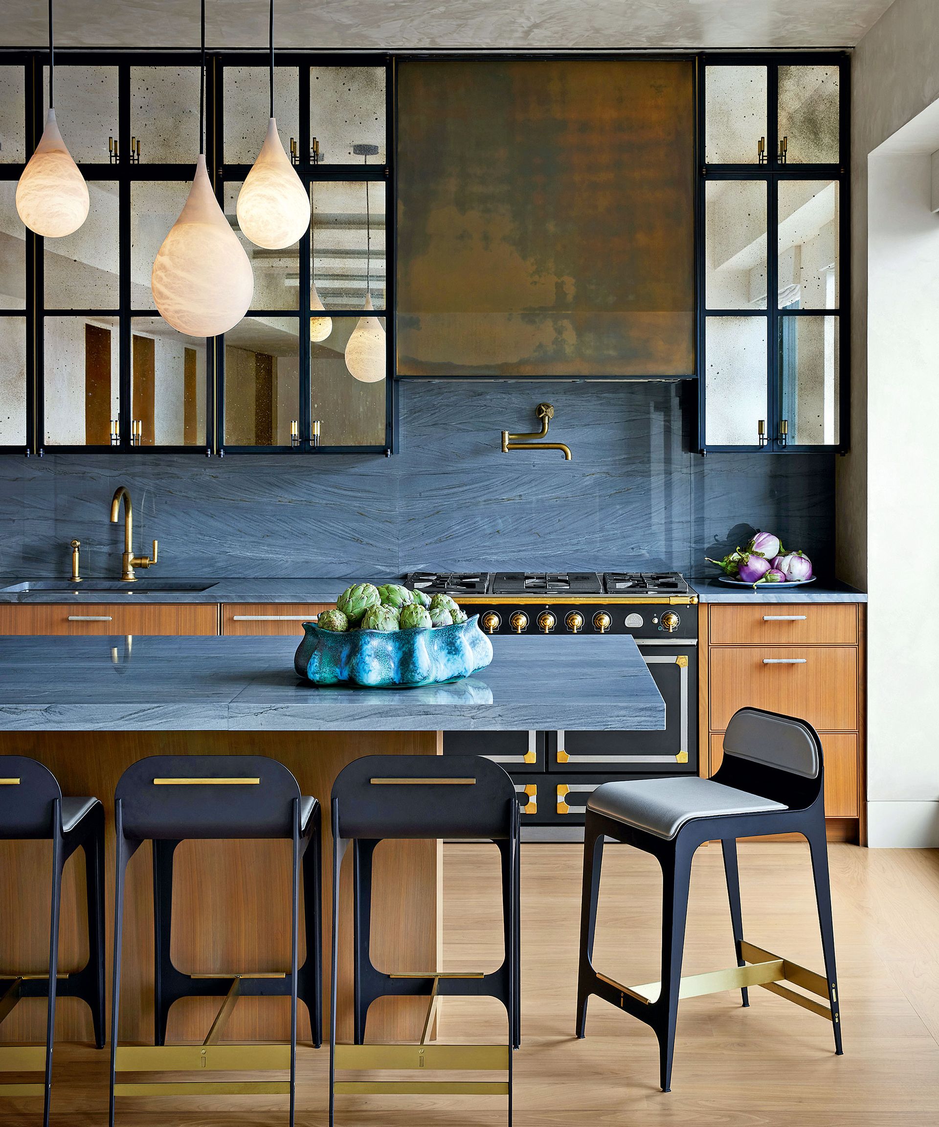 Modern kitchen with blue cabinets and mirrored backsplash