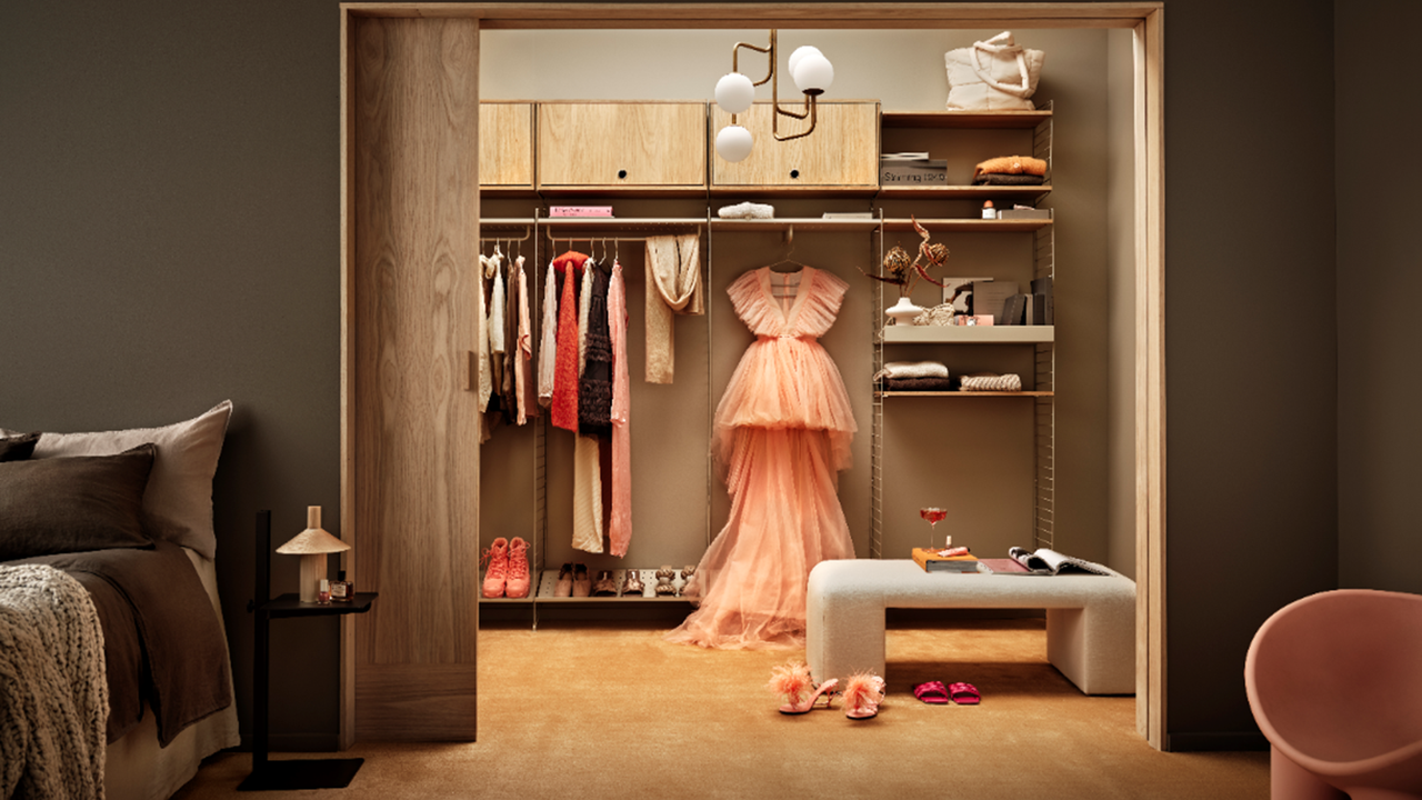 A warm brown bedroom with walk in wardrobe and modular unit