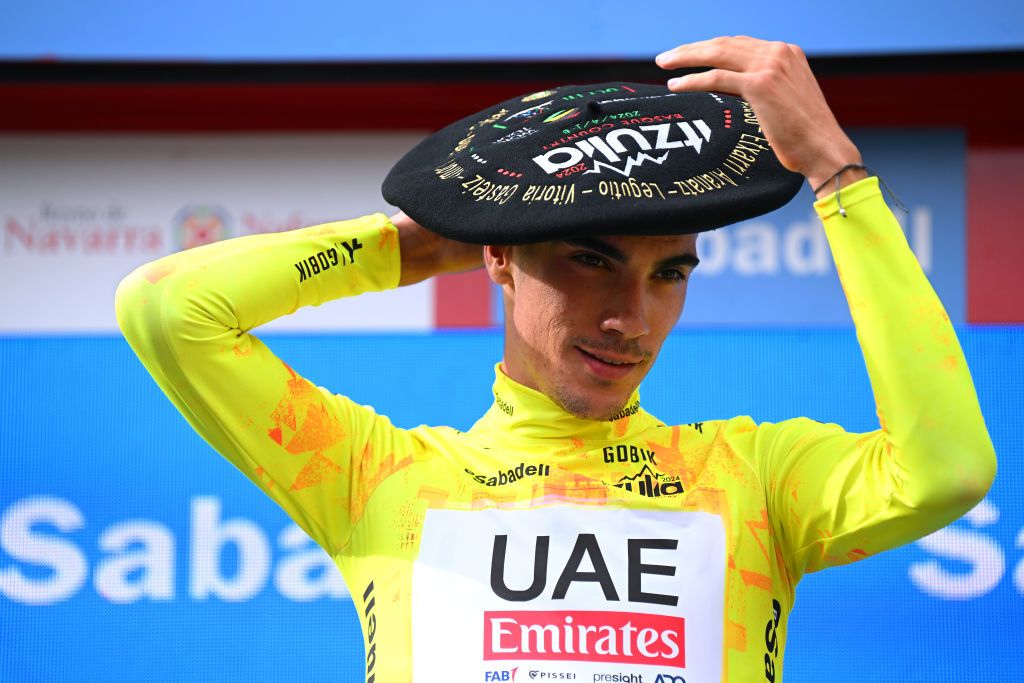 EIBAR SPAIN APRIL 06 Juan Ayuso of Spain and UAE Team Emirates celebrates at podium as Yellow Leader Jersey and overall final race winner with the Txapela hat Trophy during the 63rd Itzulia Basque Country 2024 Stage 6 a 1378km stage from Eibar to Eibar UCIWT on April 06 2024 in Eibar Spain Photo by Tim de WaeleGetty Images