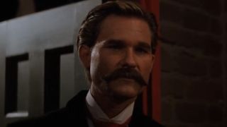 Kurt Russell with a mustache looking sincere in Tombstone