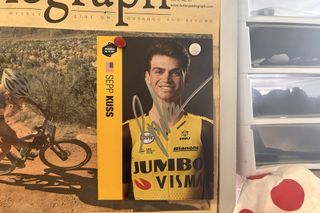 A signed Sepp Kuss rider card in Chad Cheeney's office