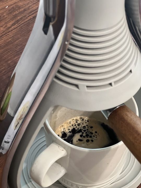 Close up image of an espresso shot in a coffee mug.