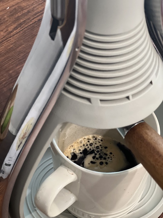 Close up image of an espresso shot in a coffee mug.