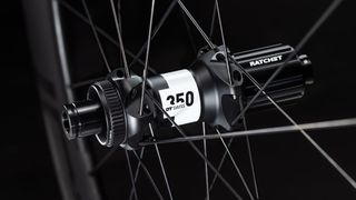 A close up of the DT350 hub from the Roval Rapide CL II wheels on a black background