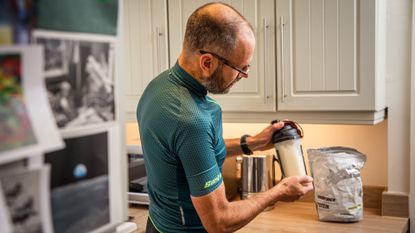 cyclist mixes whey protein shake