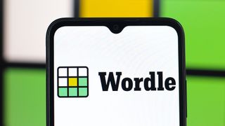 Wordle logo on a smartphone against a backdrop in Wordle's colors