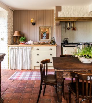 country kitchen with brick flooring and sink skirt