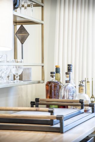 A grouping of bottles adds to the decor of this wet bar design