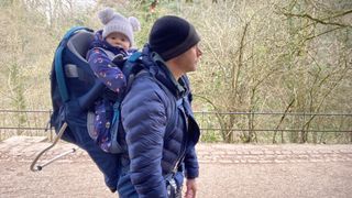 Man carrying child in Kelty Journey Perfectfit Signature carrier