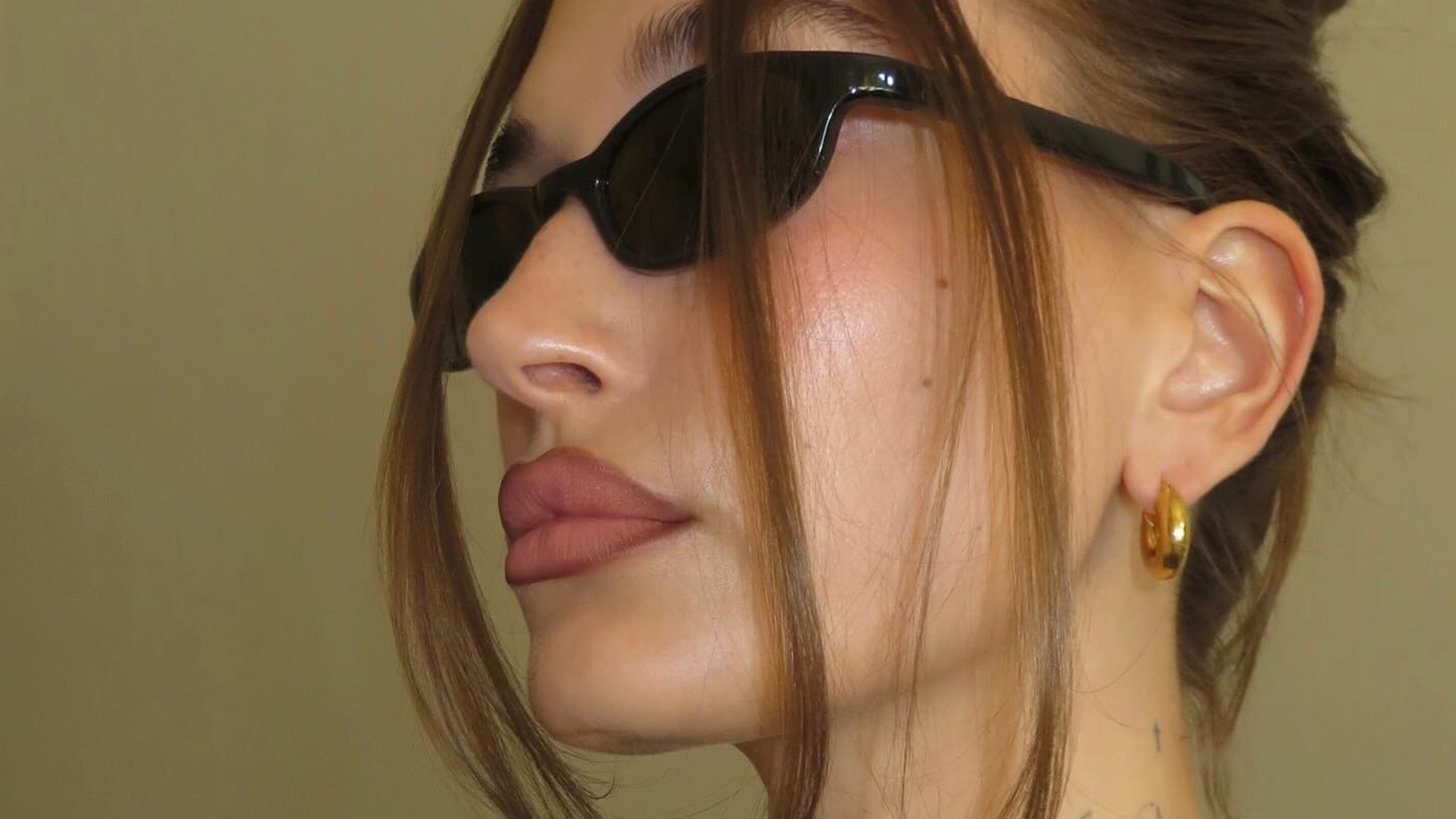 a portrait of hailey bieber wearing sunglasses.