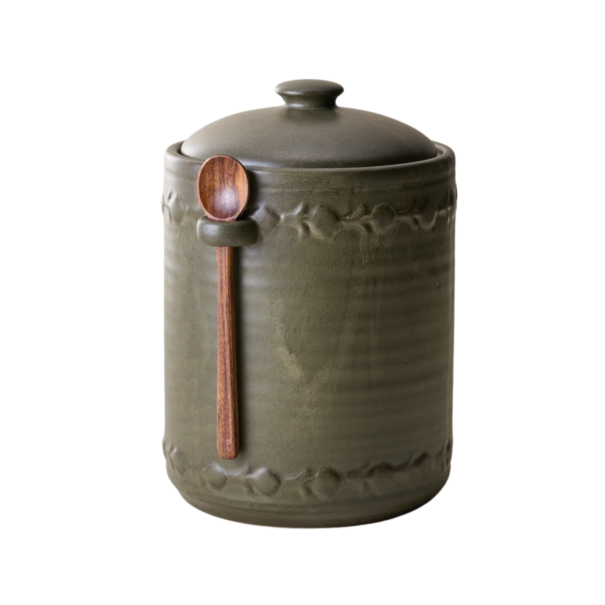 a green jar with a spoon