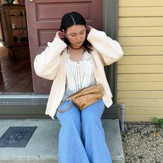 marina wears wide leg jeans white shirt and cardigan