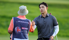 Jeong Weon Ko shakes hands with his caddie on the 18th green