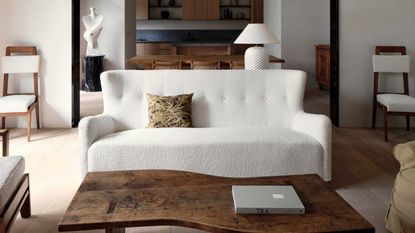 a modern living room with a boucle sofa