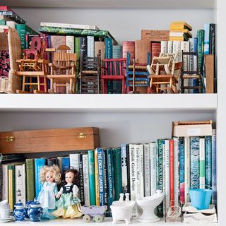 white shelf with toys and books