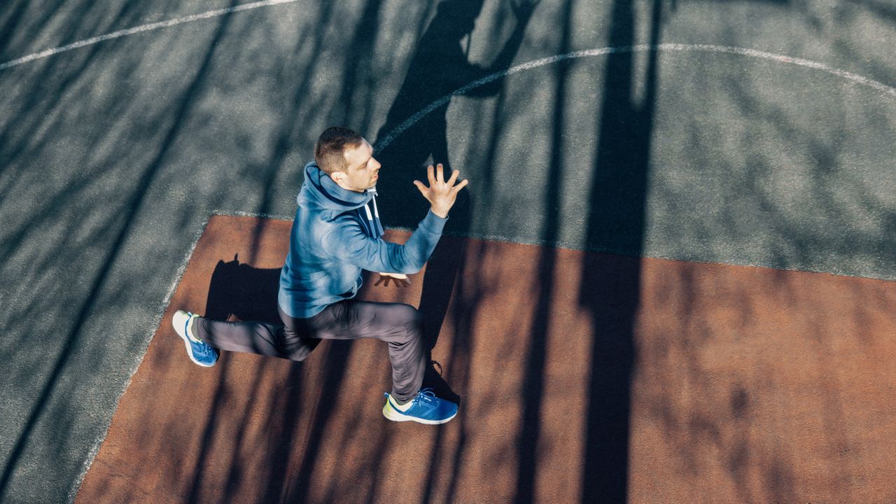 Man performing a lunge outside