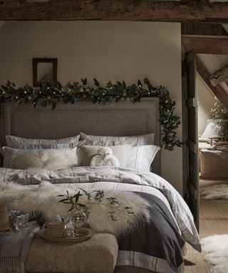 white bedroom quiet luxury christmas decor with a headboard lit garland