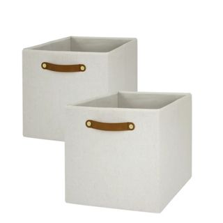Two white storage cubes with dark brown curved handles on the top edge of each one