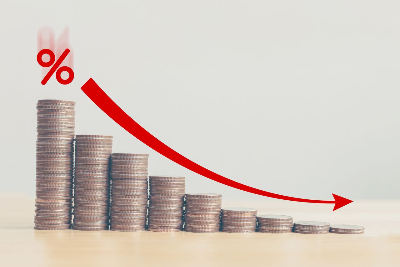 Coin stack step down graph with red arrow and percent icon, Risk management business financial and managing investment percentage interest rates concept