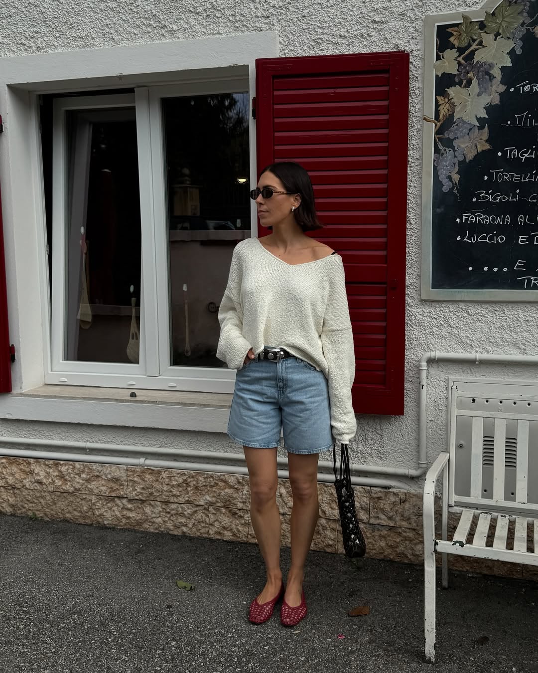 Jessica in denim shorts and white jumper