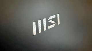 Minimalist MSI logo on the top lid of the MSI Prestige 16 AI Evo (B2HM) business laptop.