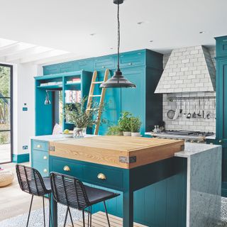 Turquoise kitchen with marble kitchen island