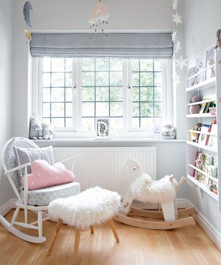 A baby girl nursery idea with gray walls, white woodwork and pink accessories.