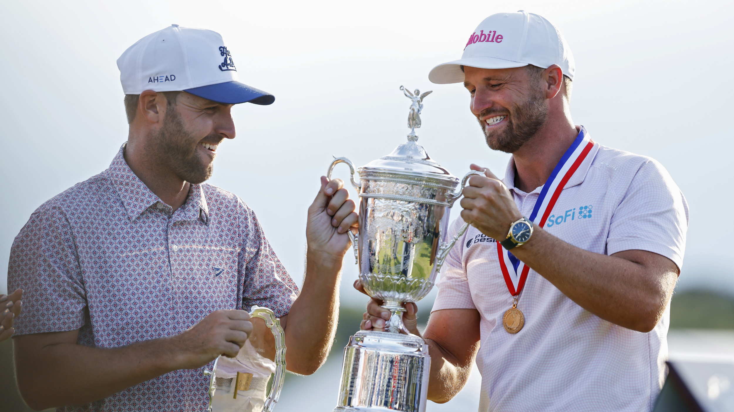 Wyndham Clark and his caddie with the US Open trophy