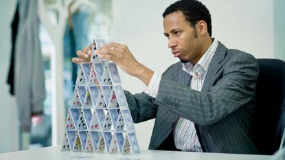 Man building a house of cards