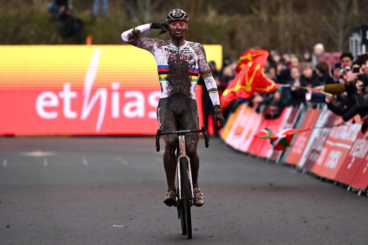 Mathieu van der Poel celebrates as he crosses the finish line to win UCI Cyclocross World Cup in Maasmechelen