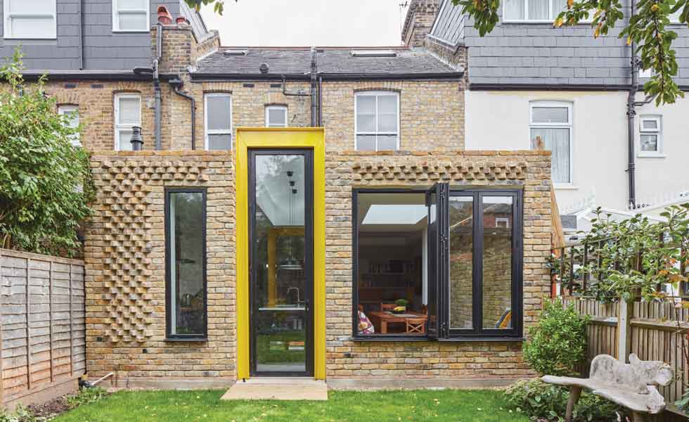 Yellow steel beam in brick extension