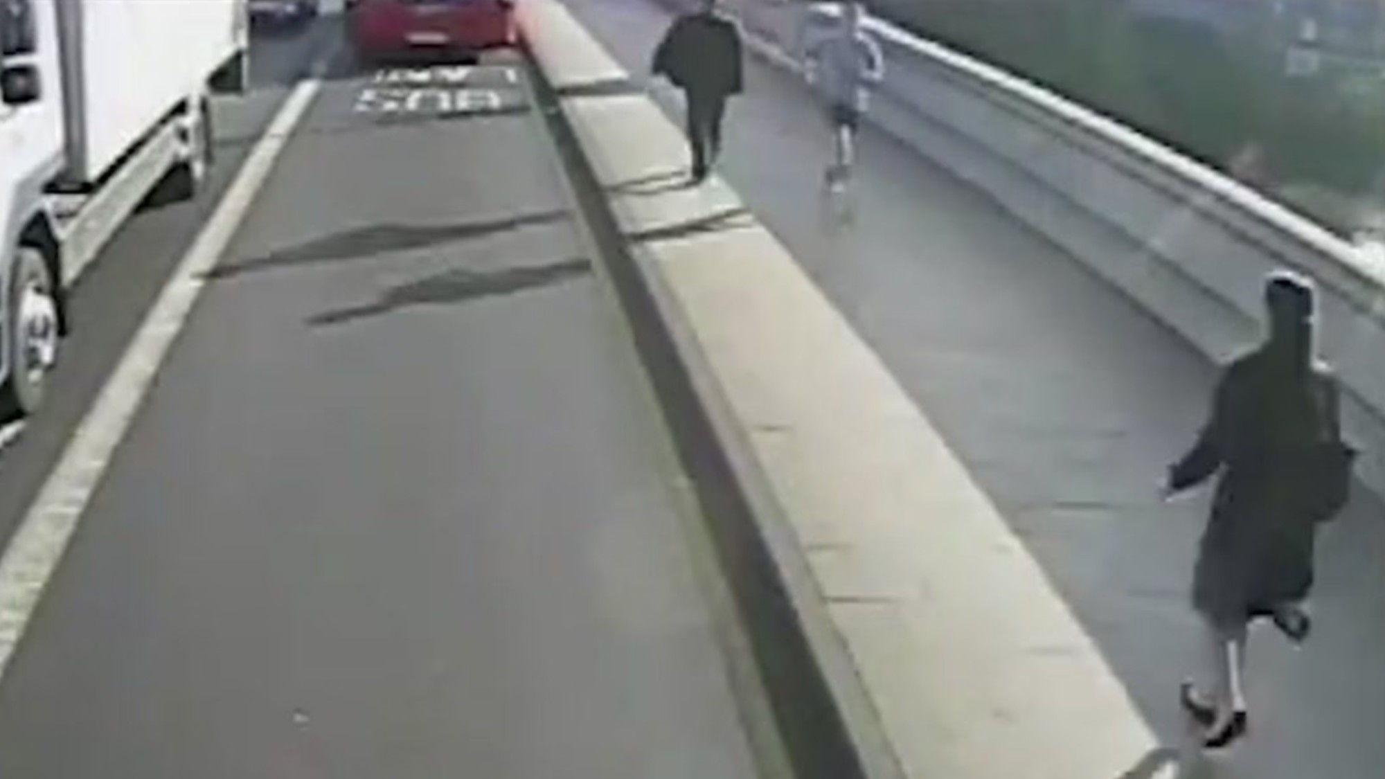 CCTV footage of a jogger running towards a woman