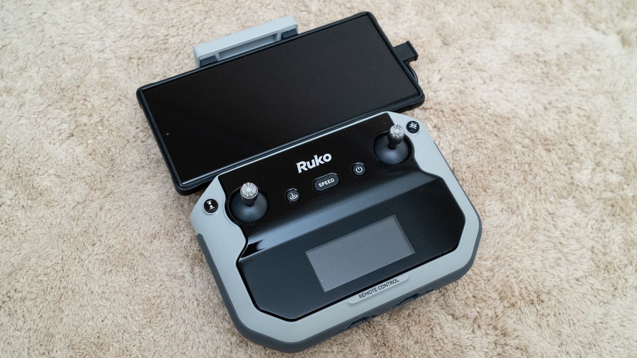 Ruko F11PRO 2 controller with a smartphone attached
