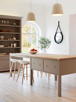a modern kitchen with back lighting above a cabinet