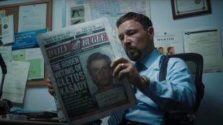 Stephen Graham reading a newspaper in Venom: Let There Be Carnage