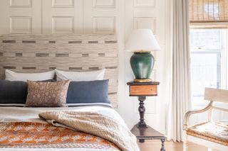 small bedroom with wovenn shades and sheer drapery by Marie Flanigan Interiors
