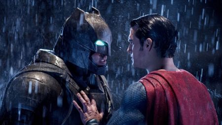 Henry Cavill as Superman placing his hand against the chest of Ben Affleck as Batman in the rain in Batman V Superman: Dawn Of Justice