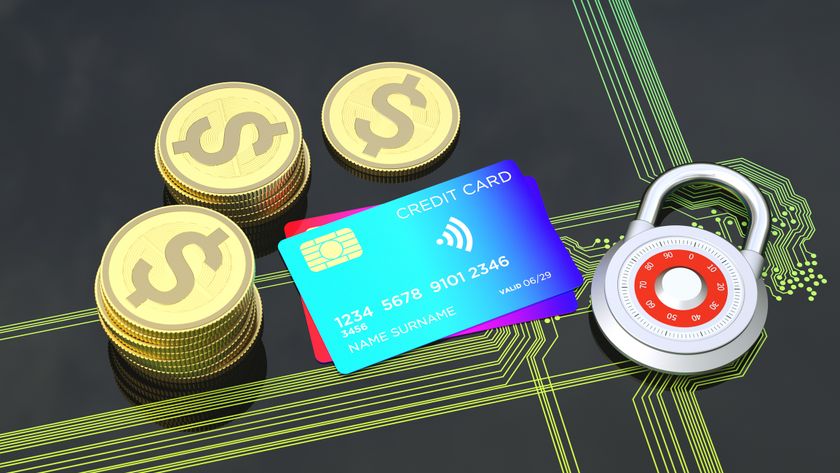 A padlock, coins and a credit card on a circuit board