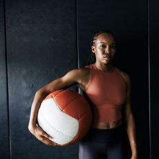 A woman strength training at a gym