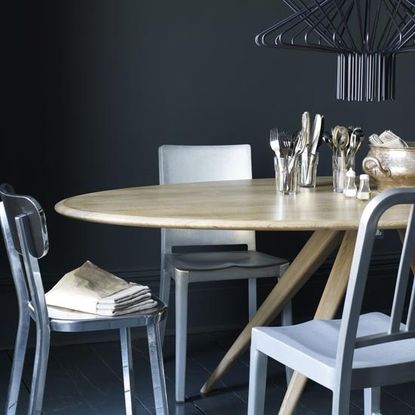 dining table with perfectly matched chairs and dark blue walls