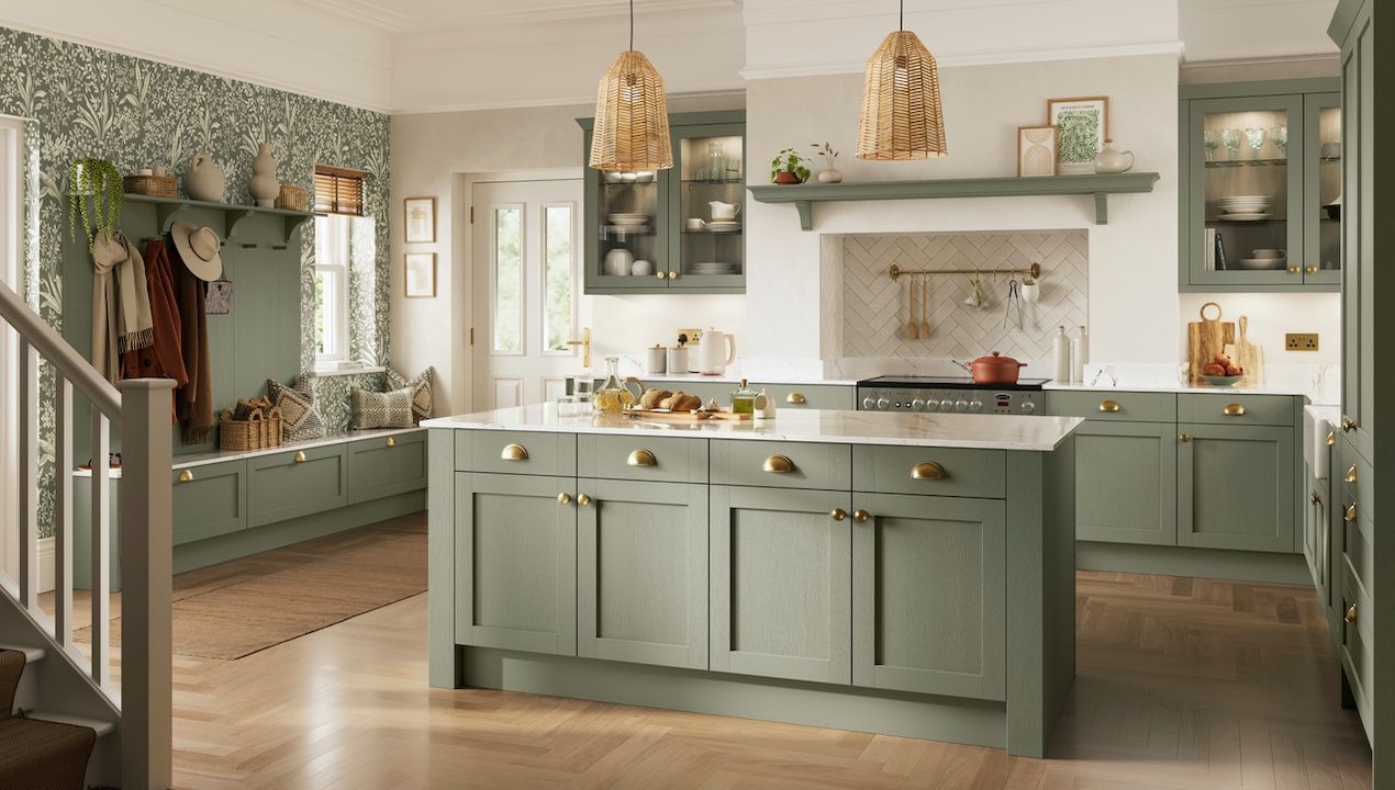 A sage green kitchen in shaker style with wood floors and wallpaper