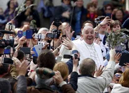 Pope Francis waves at fans after Sunday mass.