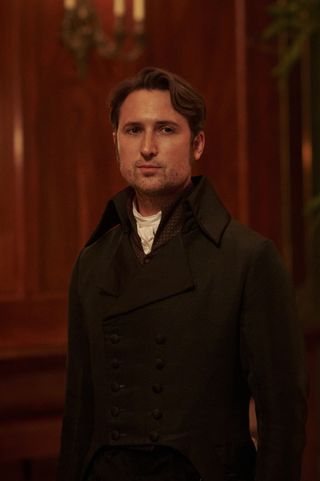 Alexander Colbourne (Ben Lloyd-Hughes) attends Georgiana's party, shot in close-up, he gazes wistfully off to the side