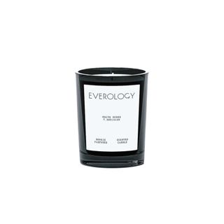 scented candle in black glass vessel with white label