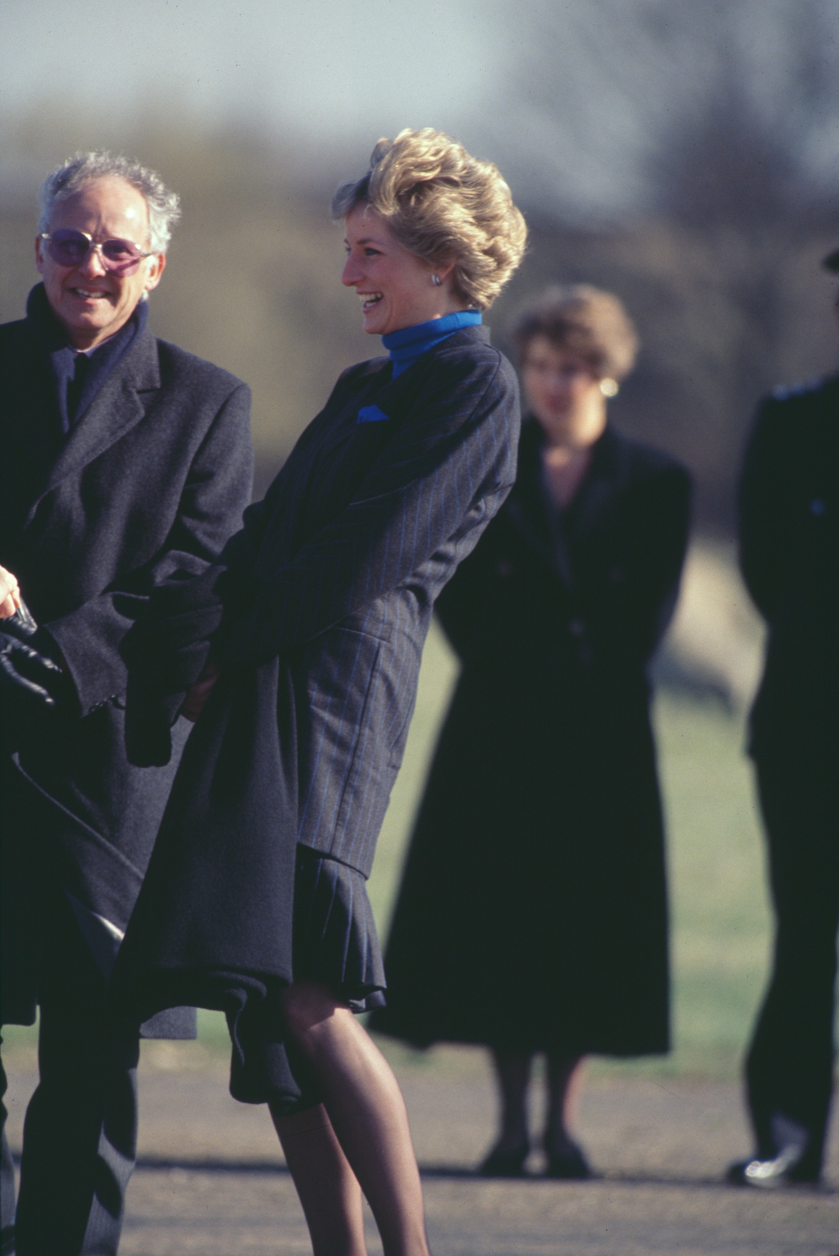 Princess Diana laughing standing next to Dickie Arbiter outside