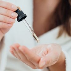 Woman dropping bisabolol serum into her palm 