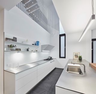 Permeable staircase structure over a sleek kitchen in contemporary Toronto suburban home