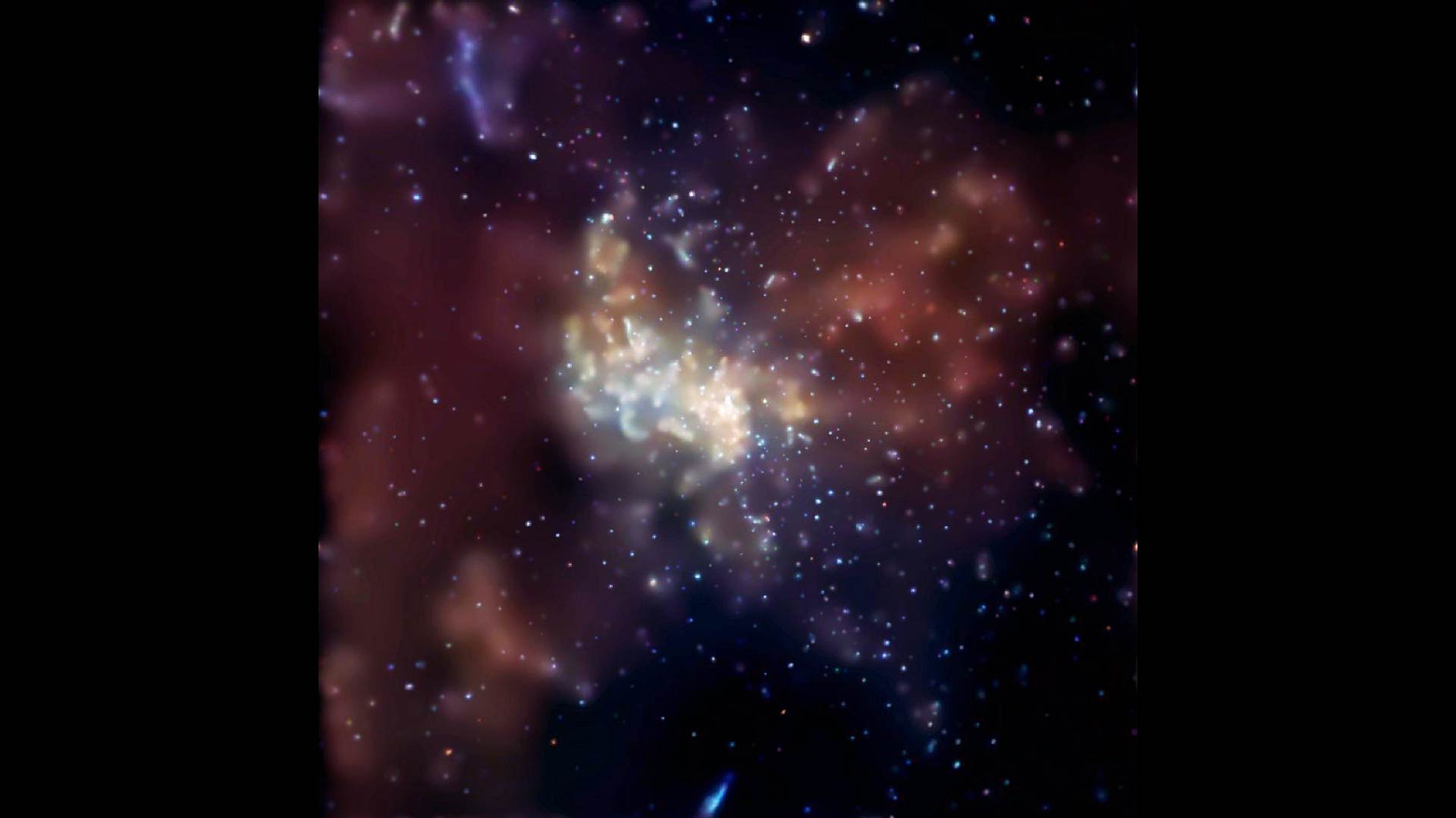 an image from the chandra x-ray observatory featuring an explosion occurring in the super massive black hole at the Milky Way's center, known as Sagittarius A or Sgr A*. Huge lobes of 20-million degree Centigrade gas ( red loops in image) flank both sides of the black hole and extend over dozens of light years.
