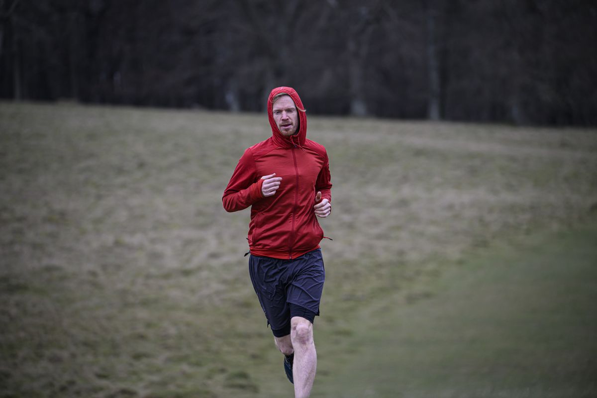 A man in a red jacket running